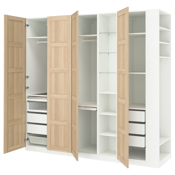 An IKEA PAX wardrobe in white and light wood. It open and closed storage with shelves and drawers.