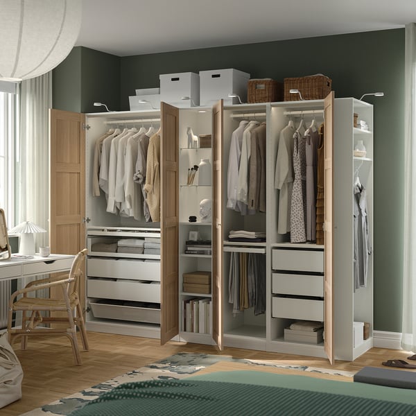 PAX wardrobe with hanging, drawer, and shelf storage, integrated lighting.
