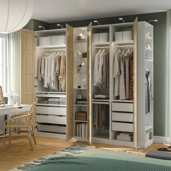 Modern, well-organized wardrobe with open and closed storage, hanging clothes, shelves, drawers, and integrated lighting.