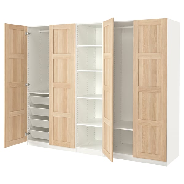 An ikea PAX wardrobe with light oak doors. It adjustable shelving and compartments, including mesh drawers for folded clothes.