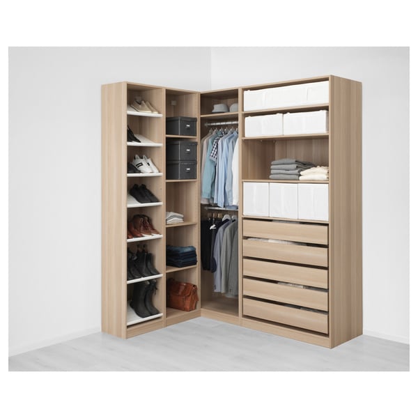 Organised corner wardrobe with shelves, shoe storage, hanging space, and drawers. PAX system efficiently utilises small room corners.