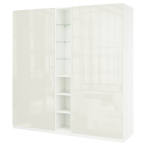 A white IKEA PAX wardrobe with shelves, featuring a sleek, modern design.