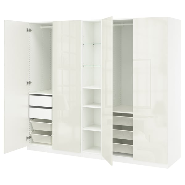 White PAX wardrobe with open doors, showing shelves, drawers, and dividers. Modern design with glossy finish.