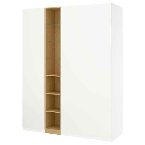 White IKEA PAX wardrobe, open section reveals light wooden shelves. Tall, rectangular, minimalist design.