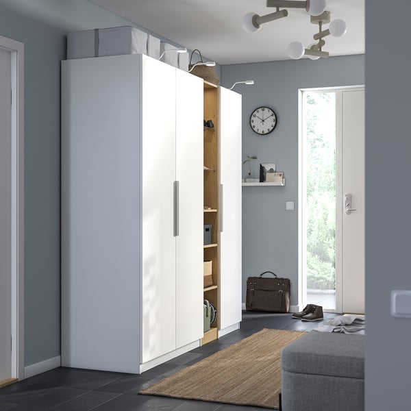 Modern entryway with large PAX wardrobe, grey walls, natural light.