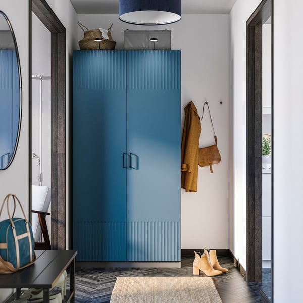 Modern blue PAX wardrobe with coat & boots; mirror, light.