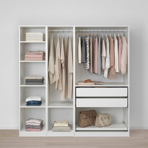 White wardrobe with clothes, textiles, and purses, minimally organised.