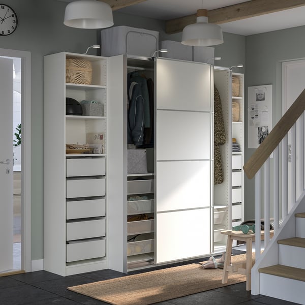 Modern, organised entryway with white PAX wardrobe, sliding doors, and storage solutions.