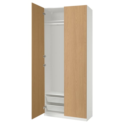 An open white and light wood-colored PAX wardrobe with shelves and drawers.
