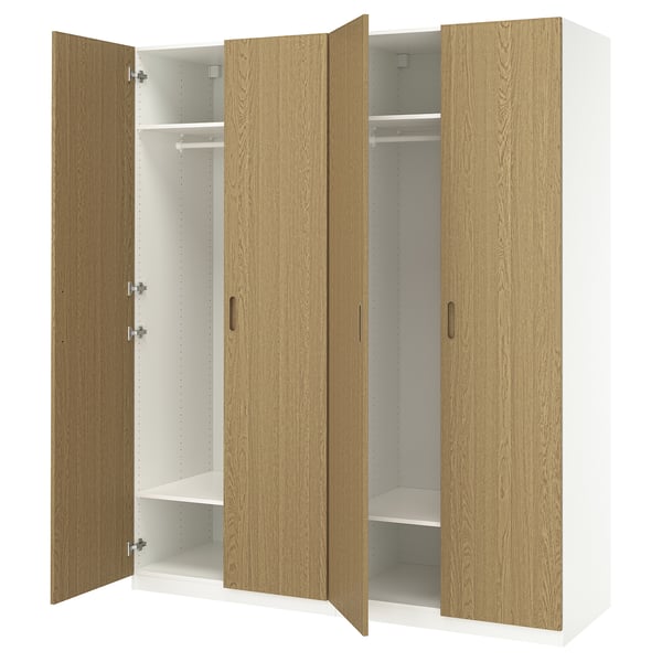 PAX wardrobe with light wood doors, fully open revealing white shelves, with handles and hinges.