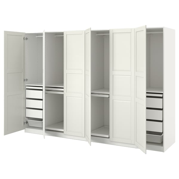 A white IKEA PAX wardrobe with open doors, showcasing adjustable shelves and drawers.