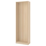 A light wood-colored PAX wardrobe frame, made of particleboard and paper foil, rectangular in shape, standing upright.