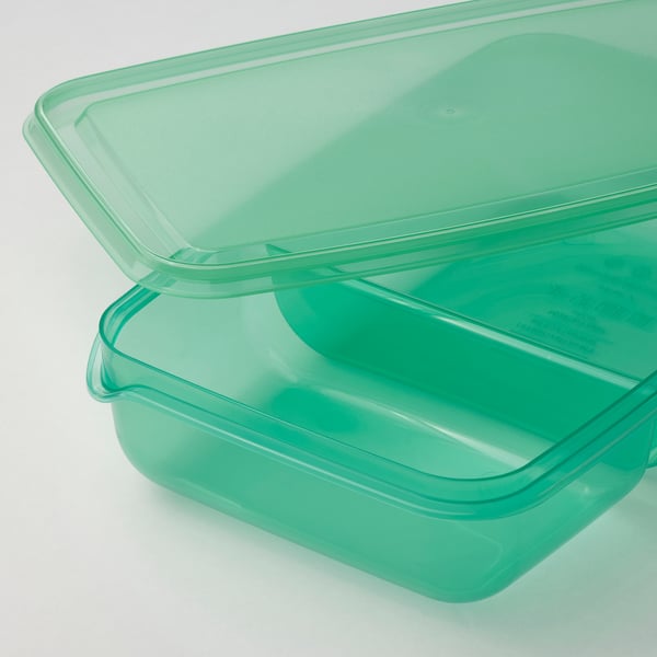 Two green plastic containers stacked; one with lid on, clear durable material.