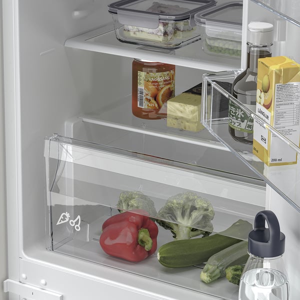 Organised fridge with adjustable shelves, veggies, drinks, and led lighting.