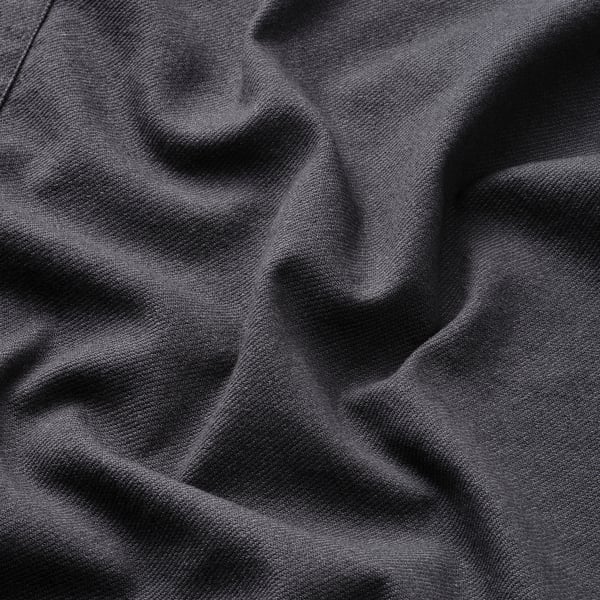 Close-up of dark fabric texture, likely an apron, showcasing quality and detail.