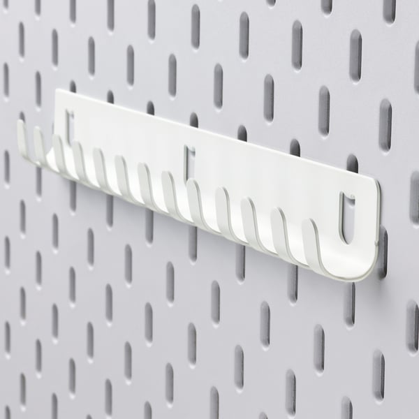 White metal pegboard with multi-hook organiser.