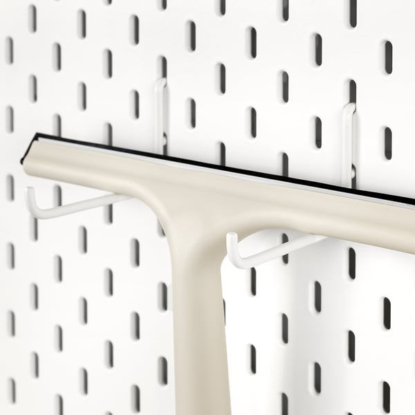 White SKÅDIS hook attached to pegboard; holds items securely.