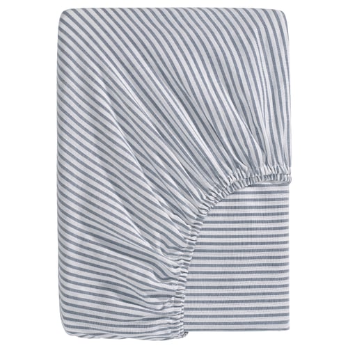 A blue and white striped fitted sheet named SOLFIBBLA made of 100% cotton with recycling content. Rectangular shape with elastic sides.