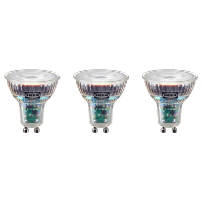 Three IKEA SOLHETTA led bulbs in warm-white light colour, rectangular shape, clear glass housing with plastic base, arranged in a row.