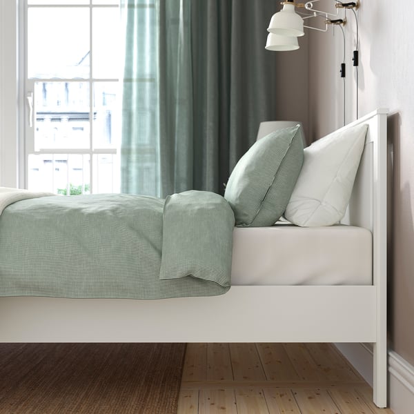 Stylish bed with adjustable sides and high legs. Mattress not shown.