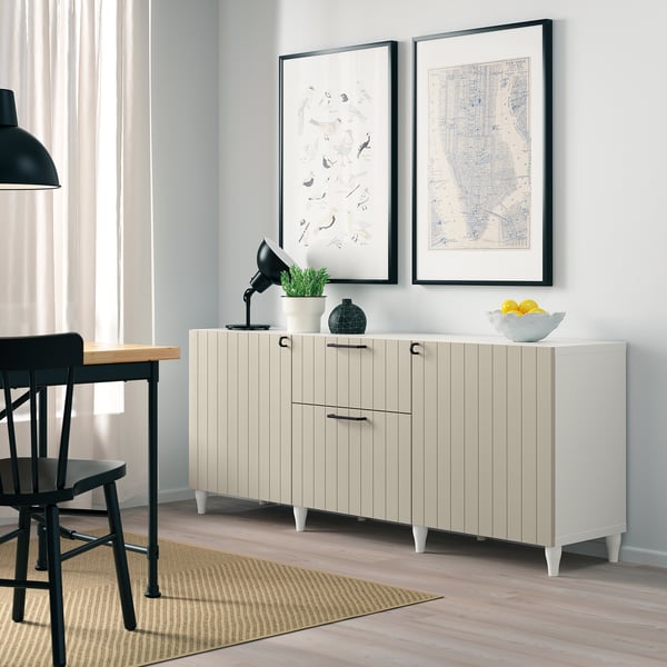 SUTTERVIKEN sideboard. Drawers & cabinets. Grey wall, black furniture, prints, plant.