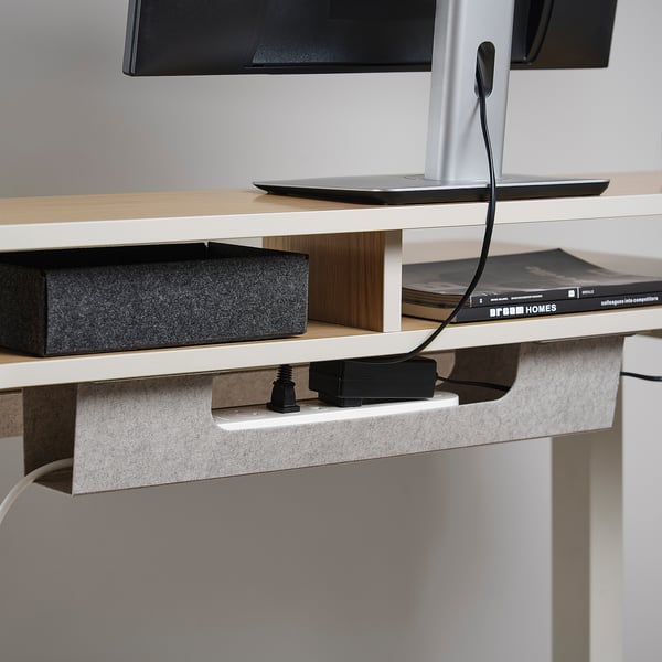 Desk with adjustable shelf, powered by a control box for height customization.