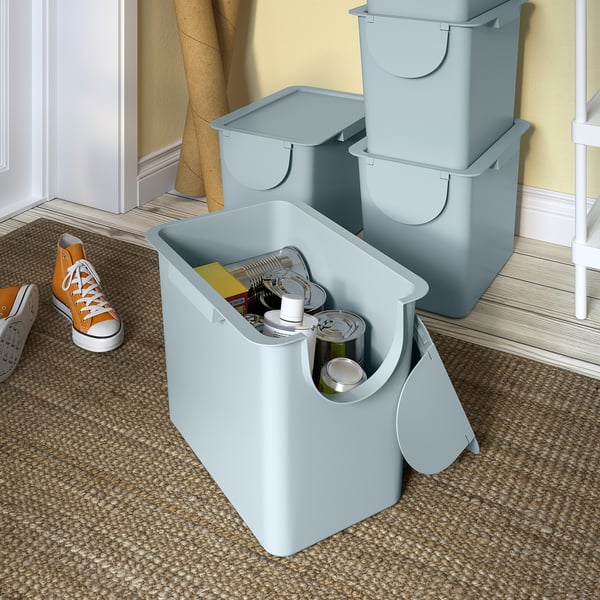 Three blue TRÖSKNING bins with one open, showing waste inside, suitable for indoor use.