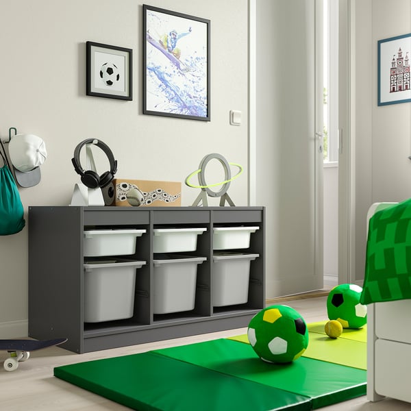 Kids TROFAST grey storage unit with white bins. Holds toys, gear. Fits below wall art.