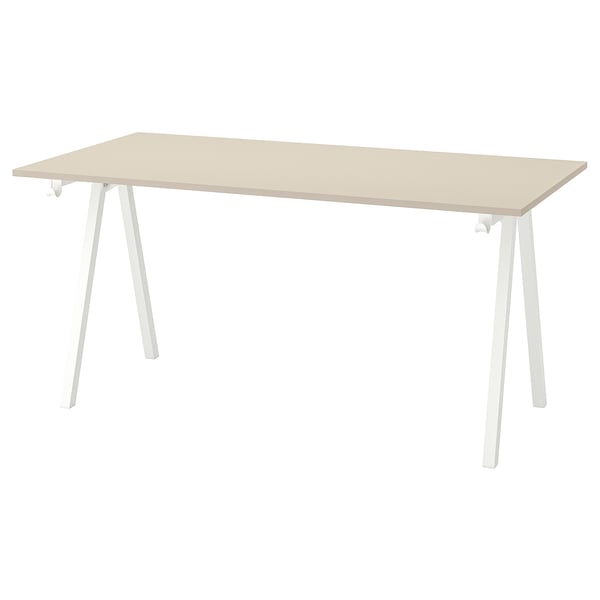 A TROTTEN desk in light beige with white metal legs, rectangular shape, modern design.