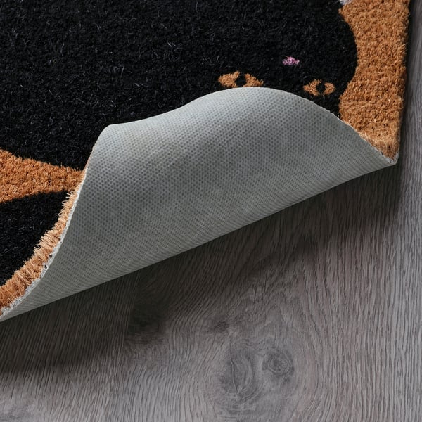 Door mat with cats turned up edge revealing backing, designed for indoor use, coir material, non-slip.