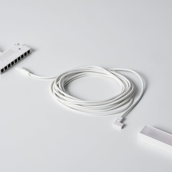 A white coiled cable for connecting led lights, shown with a connector box.