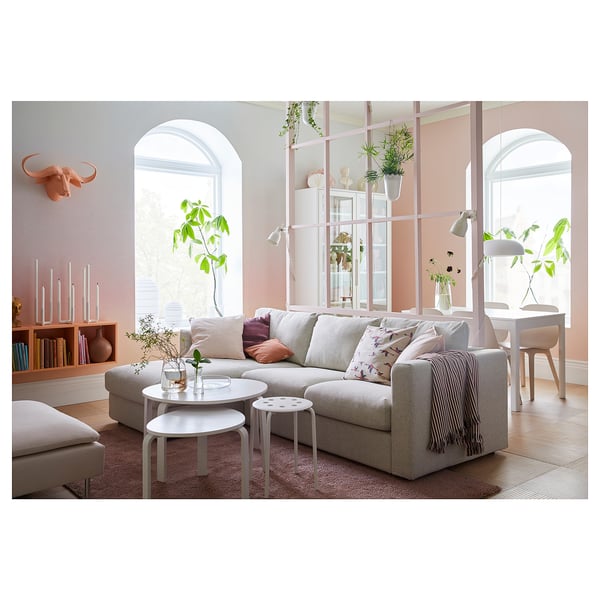 Modern living room with VIMLE sofa in neutral fabric, white coffee table, grey rug, and natural decor.