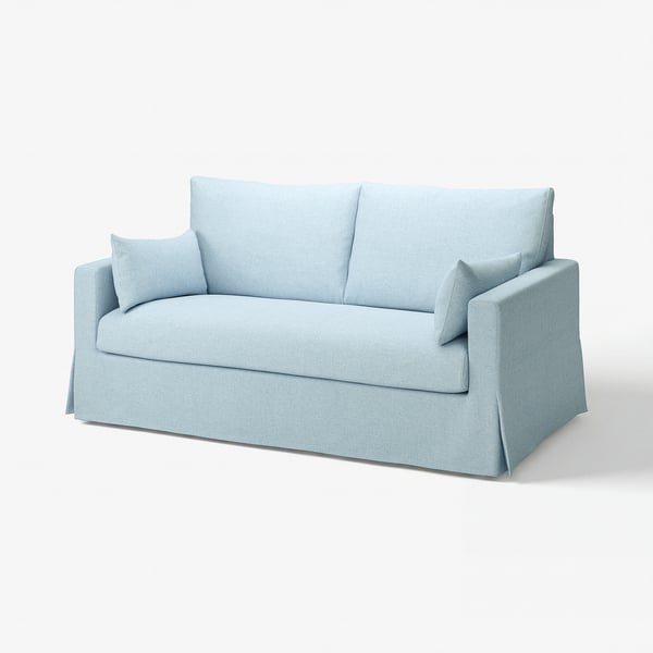Hele sinine, kaasaegne diivan puhaste joonte ja pehmete patjadega.