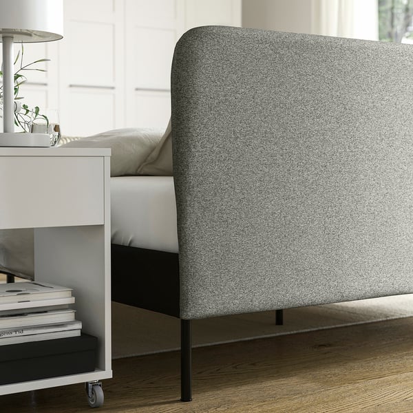Voodiraam eemaldatava kattega laua lähedal.