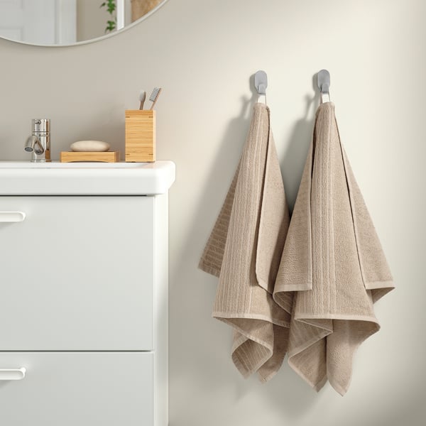 Kaks triibulist VÅGSJÖN rätikut ripuvad vannitoas tualettruumi kõrval.
