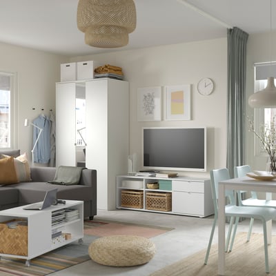 Kaasaegne elutuba halli VIHALS televiisori aluse, halli diivaniga, valge riidekapi, lameekraaniga televiisori ja loomuliku valgusega; minimalistlik disain.