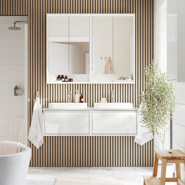 Modern bathroom with ÄNGSJÖN vanity, mirror, handles, storage, towel rack, and plant.