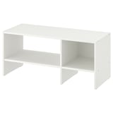 A BAGGEBO tv bench in white. It has a minimalist design with open storage. Crafted from particleboard and fiberboard, it two open shelves for storage.