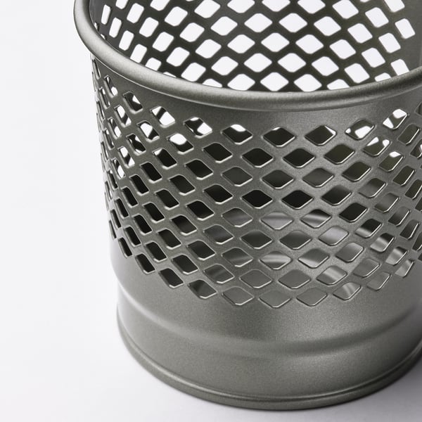 Metal candle holder with intricate cutouts, emits soft glow, sleek and modern.