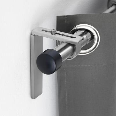 BETYDLIG silver curtain rod holder mounts on wall or ceiling. Adjustable, fits multiple curtain rod sizes. Small, sleek design.
