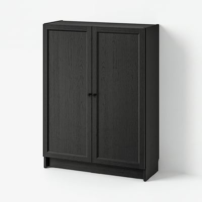 A BILLY bookcase in dark grey with two doors, made from particleboard and fiberboard, featuring a simple and versatile design.