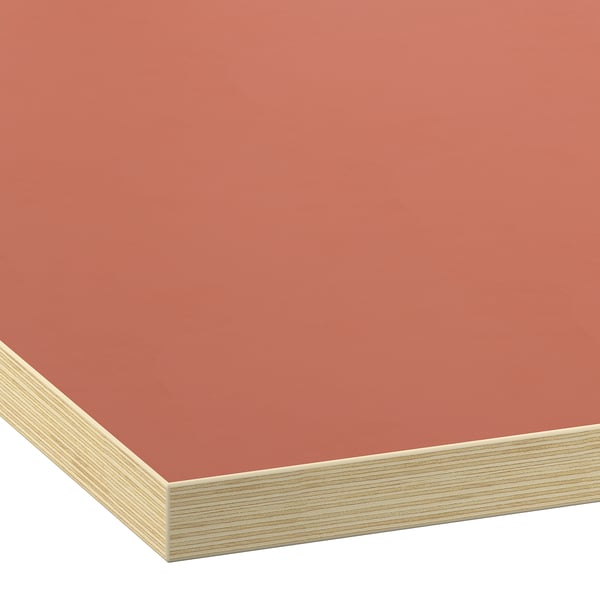 Close-up of smooth, modern orange worktop with elegant, seamless edge detail.