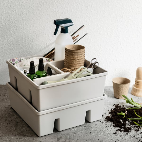 Beige FÅNGGRÖDA organiser for gardening tools, durable plastic.