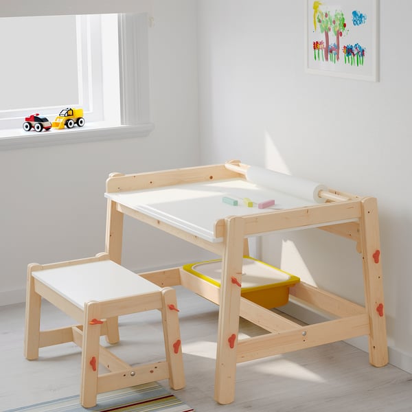 Kids FLISAT light wood bench, multi-height, yellow, with matching desk and toys.
