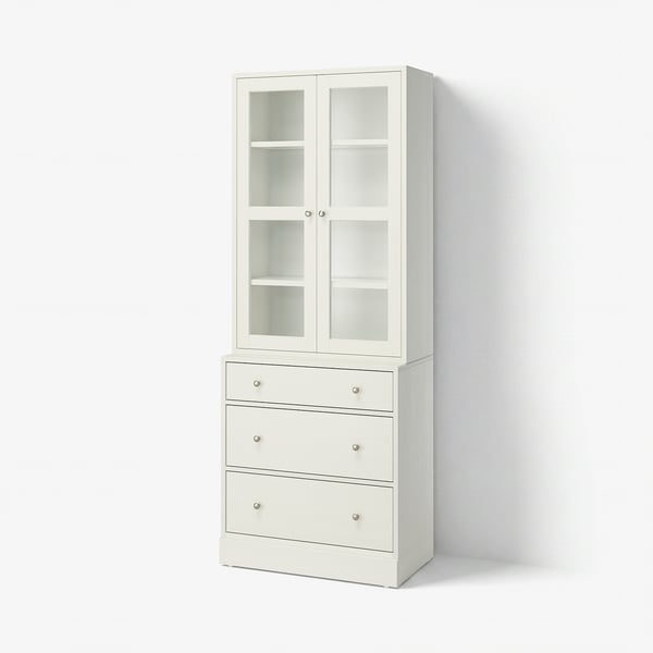 White HAVSTA set: glass-door cabinet, wooden chest with silver handles.
