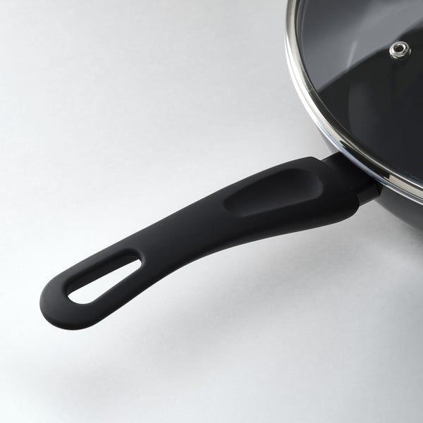 Kitchen pan with black handle and glass lid, quality design for even heat distribution.