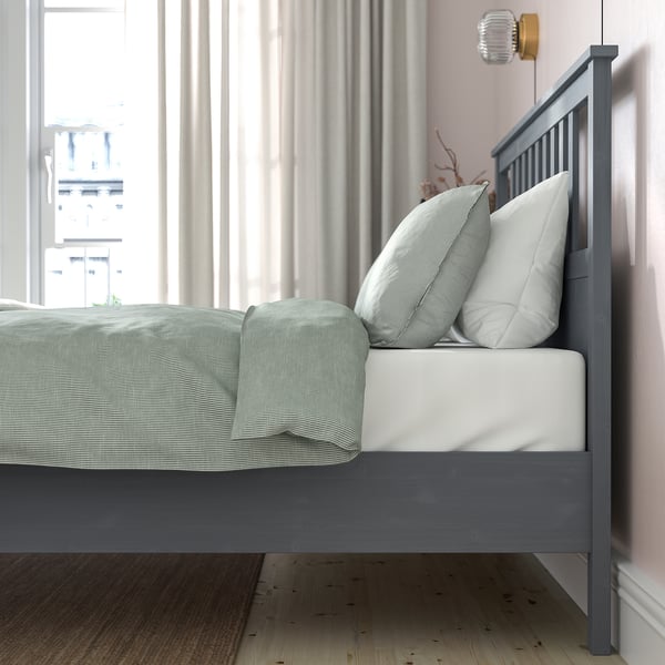Cosy bedroom with grey HEMNES bed & soft pink walls.