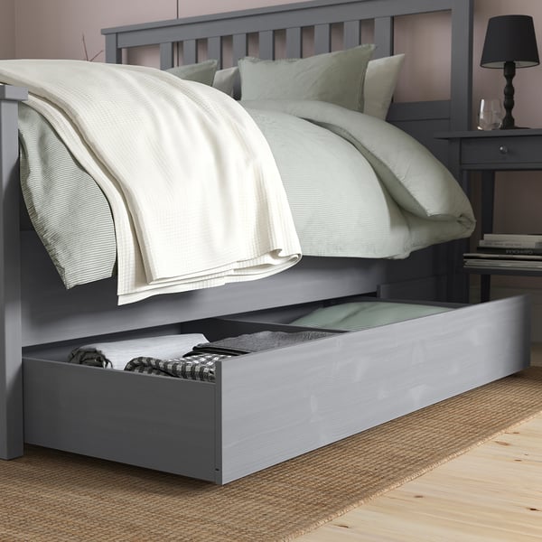Neat bedroom with a grey HEMNES bed featuring adjustable bed sides and large under-bed storage drawers for extra linens.