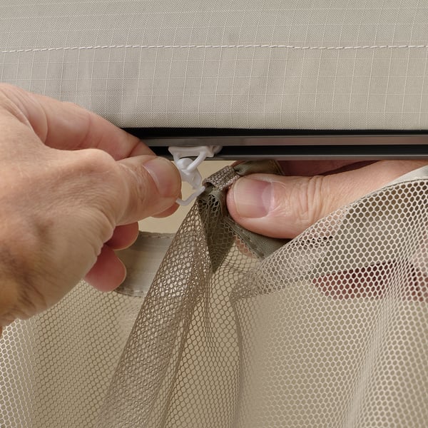 Installing HIMMELSÖ mesh screen: securing with clips for insect protection.
