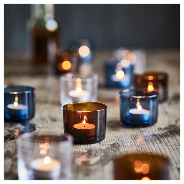 HÖSTAGILLE: blue glass tealight holders. Small, round, simple design. Used individually or in groups for warm autumn ambiance.